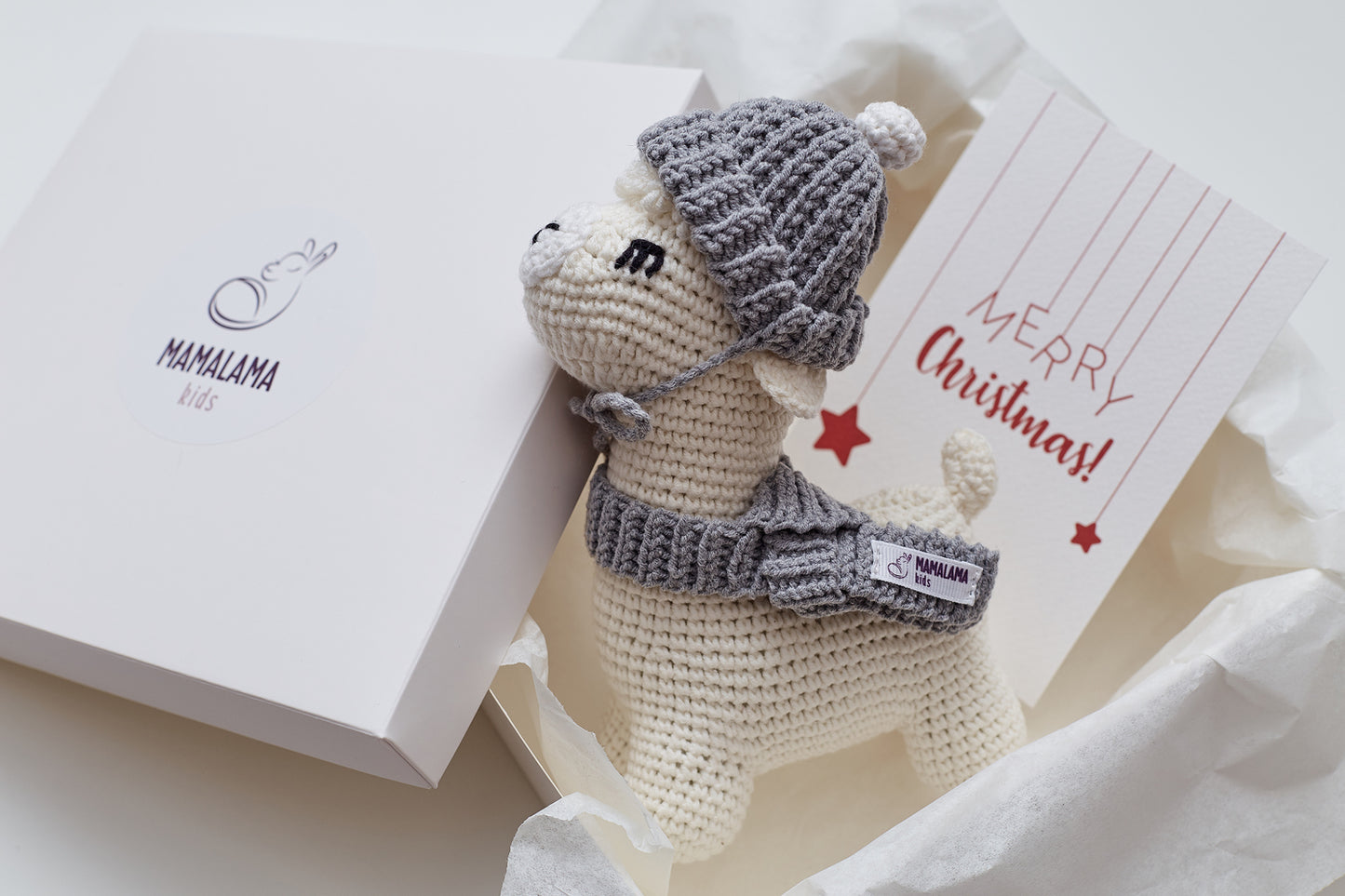 Christmas llama in a gray hat toy gift box Off white